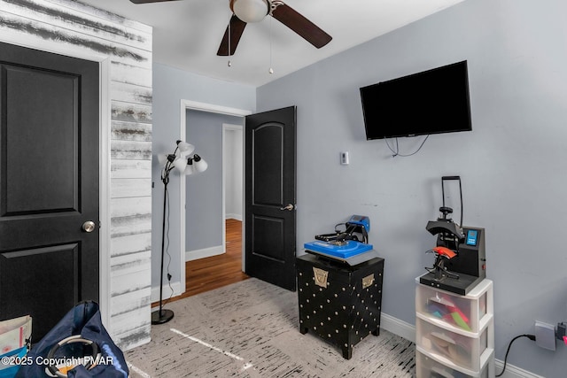 bedroom with ceiling fan, baseboards, and wood finished floors