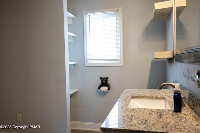 bathroom featuring vanity and baseboards