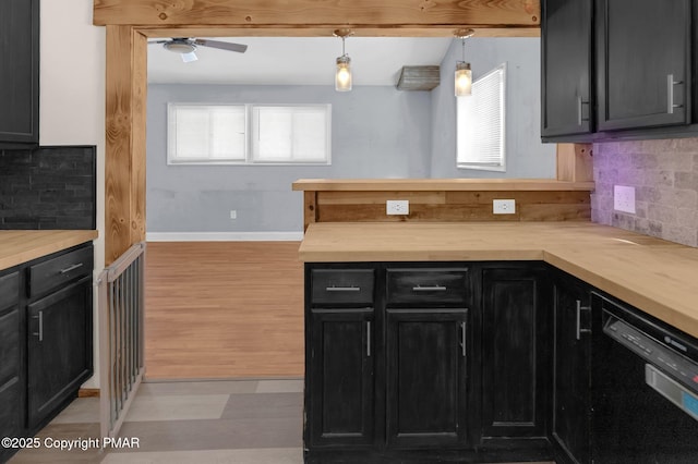 kitchen with black dishwasher, tasteful backsplash, a peninsula, dark cabinetry, and light wood-type flooring