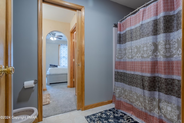 ensuite bathroom featuring ensuite bath, baseboards, and a shower with shower curtain