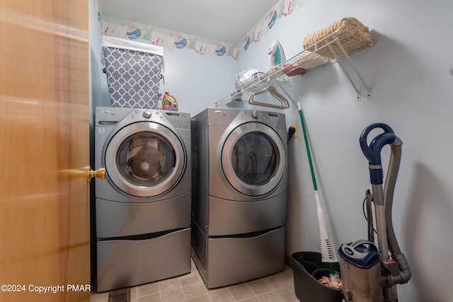 laundry room featuring laundry area, light tile patterned floors, and washer and dryer