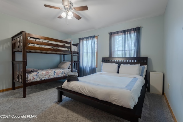 bedroom with carpet flooring, a ceiling fan, and baseboards