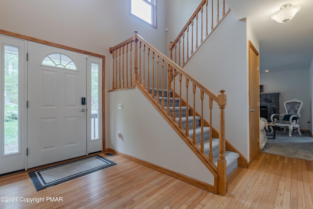 entryway with plenty of natural light, baseboards, and hardwood / wood-style floors