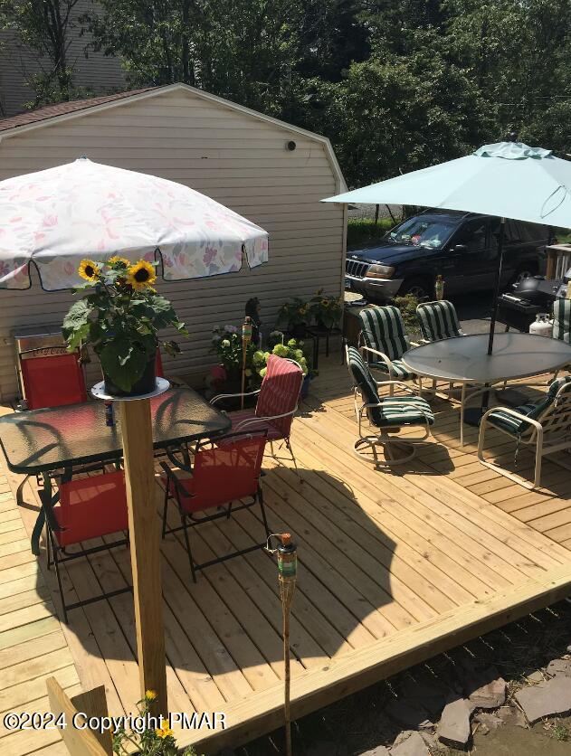 wooden terrace with outdoor dining area