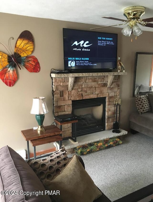 living room with a fireplace and a ceiling fan