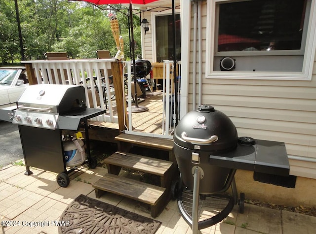 wooden terrace featuring area for grilling