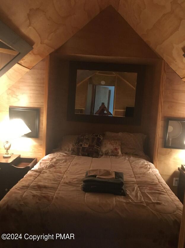 bedroom featuring lofted ceiling