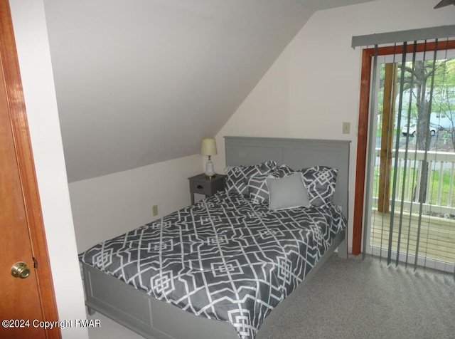 carpeted bedroom with lofted ceiling and access to outside