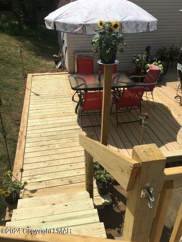 wooden terrace featuring outdoor dining space