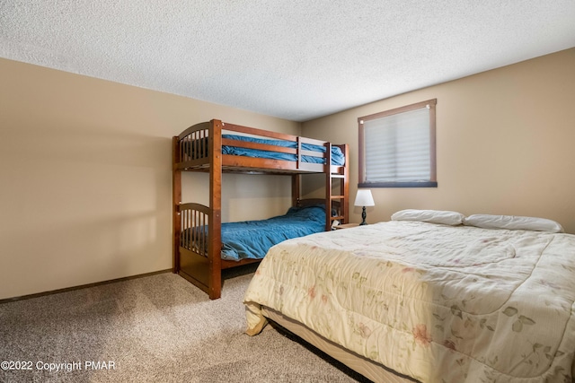 carpeted bedroom with baseboards and a textured ceiling