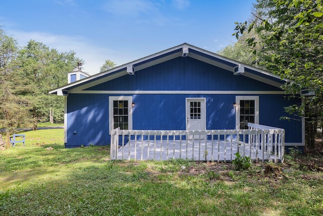 3119 Essex Rd, Coolbaugh Township, PA 18466 - rear view of property with a lawn, a chimney, and a wooden deck