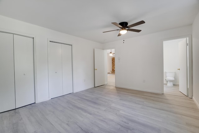 3119 Essex Rd, Coolbaugh Township, PA 18466 - unfurnished bedroom with two closets, light wood-style flooring, ensuite bathroom, and ceiling fan