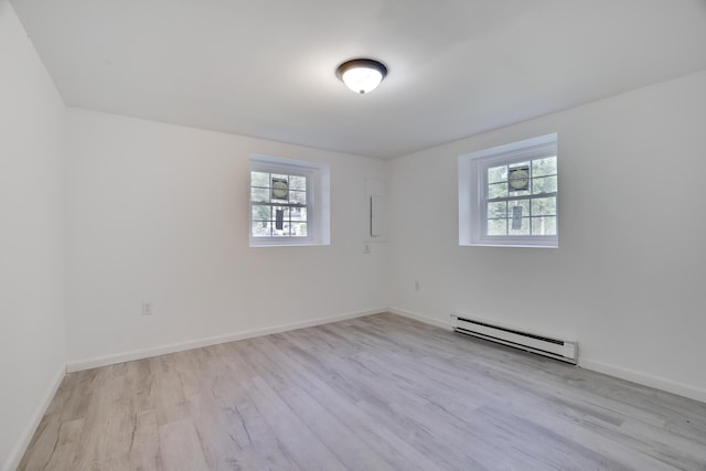 3119 Essex Rd, Coolbaugh Township, PA 18466 - spare room with baseboard heating, plenty of natural light, and wood finished floors