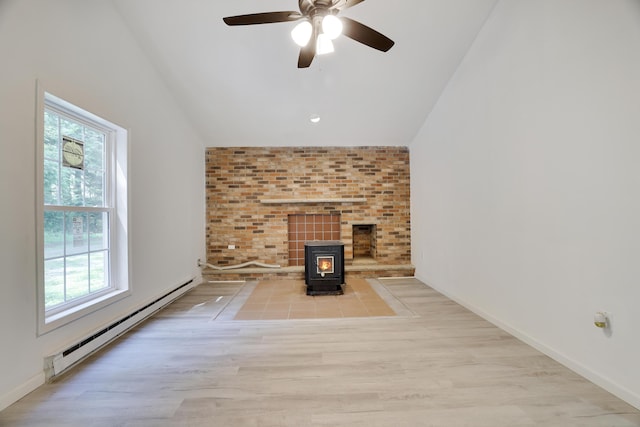 3119 Essex Rd, Coolbaugh Township, PA 18466 - unfurnished living room with a baseboard radiator, lofted ceiling, a wood stove, a ceiling fan, and wood finished floors