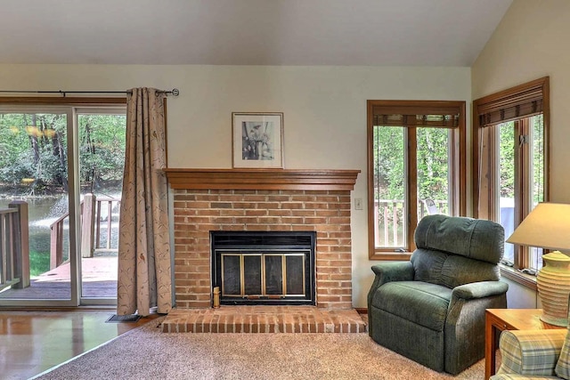 living area with a fireplace and vaulted ceiling