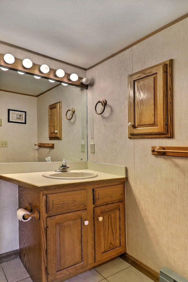 bathroom with tile patterned flooring, crown molding, and vanity