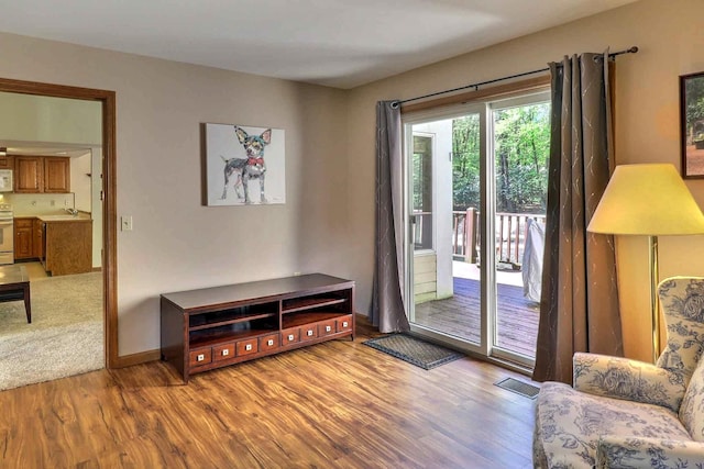 doorway featuring wood finished floors and baseboards