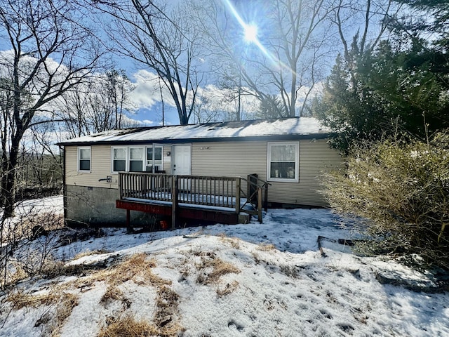 view of front of home with a deck and crawl space