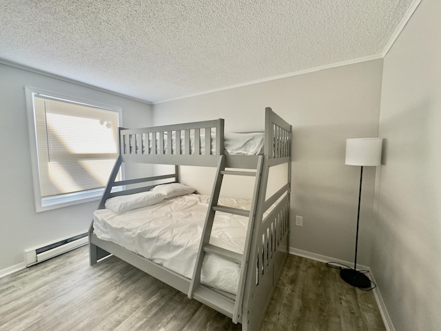 bedroom featuring wood finished floors, baseboards, and a baseboard radiator