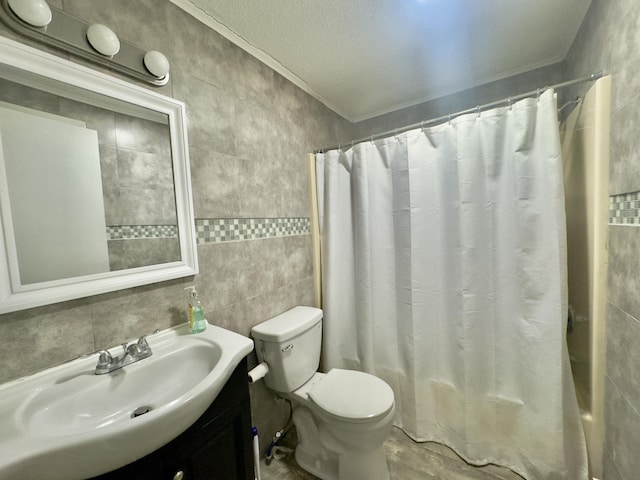 full bathroom with vanity, shower / bath combination with curtain, crown molding, tile walls, and toilet