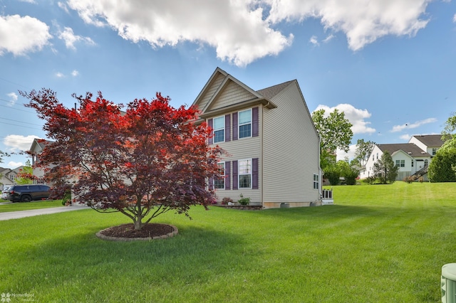 view of home's exterior with a yard