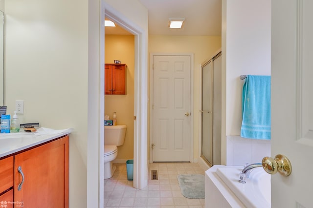 full bathroom featuring toilet, a stall shower, a bath, and vanity