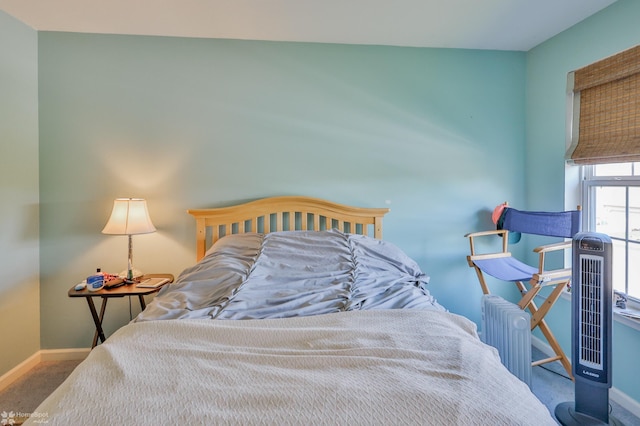 bedroom featuring carpet floors, baseboards, and radiator