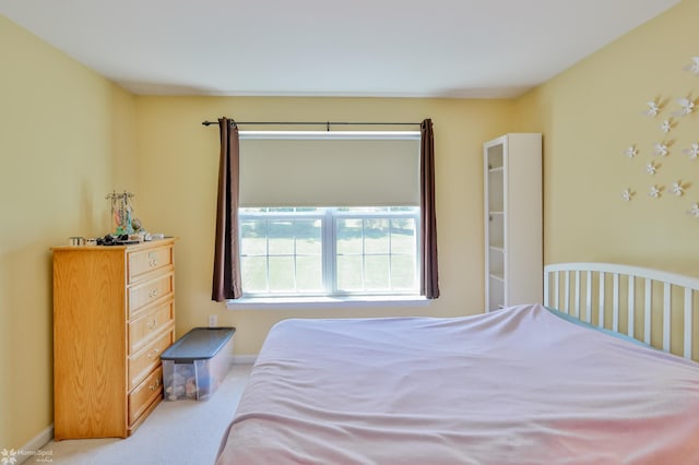 bedroom with carpet flooring and baseboards