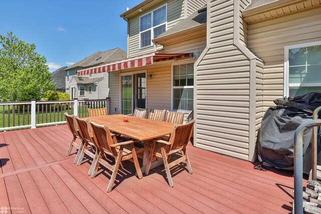 wooden terrace featuring outdoor dining area