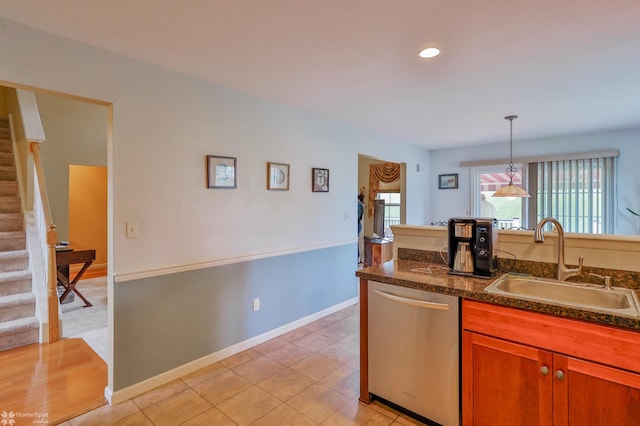 kitchen featuring stainless steel dishwasher, a sink, pendant lighting, brown cabinetry, and recessed lighting