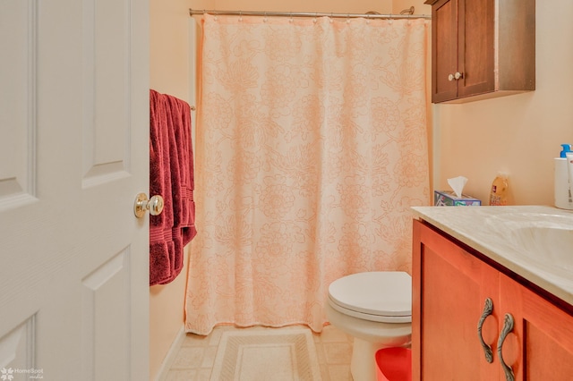 bathroom featuring toilet, vanity, tile patterned floors, and a shower with curtain