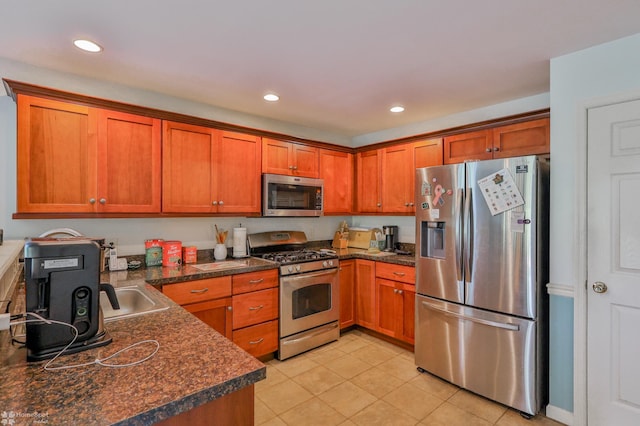 kitchen with appliances with stainless steel finishes, dark countertops, brown cabinets, light tile patterned floors, and recessed lighting