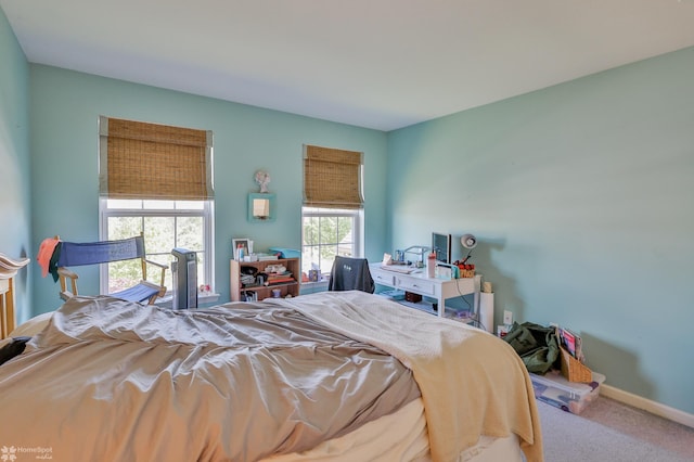 carpeted bedroom featuring baseboards
