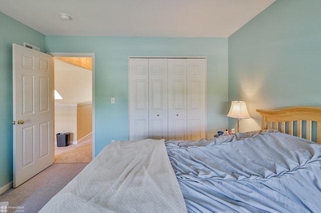 bedroom featuring carpet, a closet, and baseboards