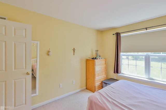 bedroom featuring carpet and baseboards