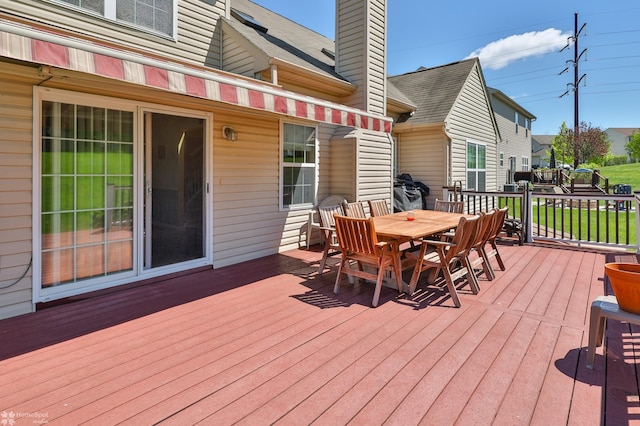 wooden deck with outdoor dining space