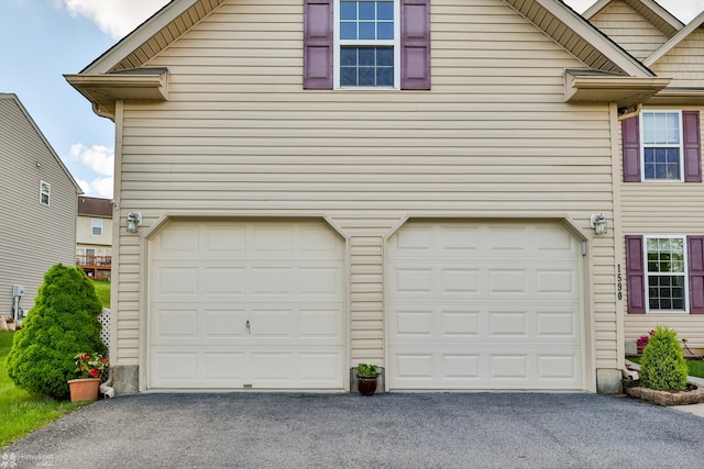 garage with asphalt driveway