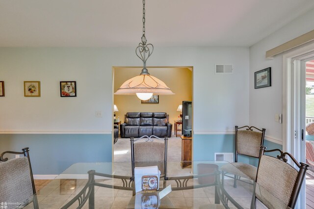 tiled dining room with baseboards