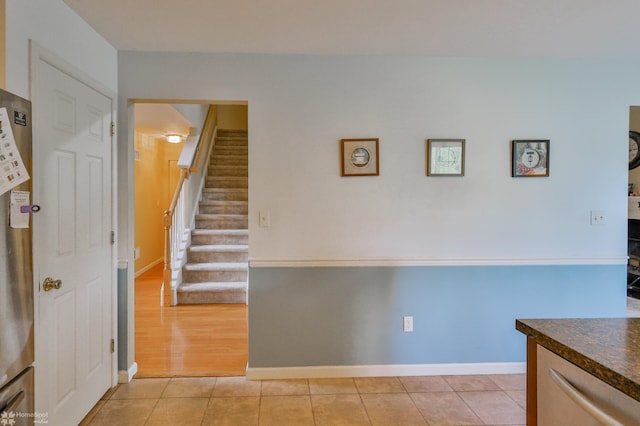stairs with tile patterned floors and baseboards