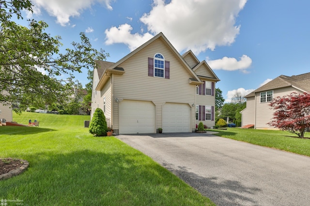 view of front of house with a garage, asphalt driveway, and a front lawn