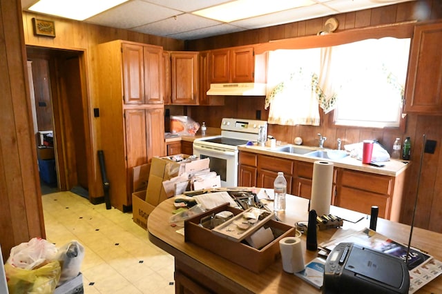 595 N Courtland St, East Stroudsburg, PA 18301 - kitchen with under cabinet range hood, white electric range oven, wood walls, light countertops, and light flooring