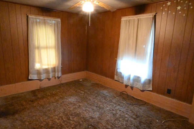 595 N Courtland St, East Stroudsburg, PA 18301 - spare room featuring wooden walls, ceiling fan, and carpet flooring