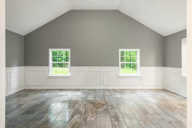 1572 Gardner Rd, Stroudsburg, PA 18360 - spare room featuring healthy amount of natural light, a wainscoted wall, high vaulted ceiling, and a decorative wall