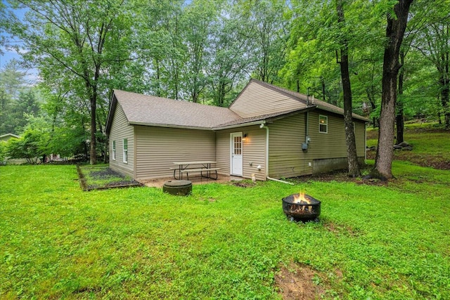 1572 Gardner Rd, Stroudsburg, PA 18360 - rear view of house with an outdoor fire pit, a lawn, and a shingled roof