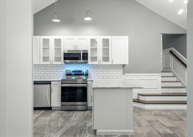 1572 Gardner Rd, Stroudsburg, PA 18360 - kitchen with stainless steel appliances, white cabinets, light stone countertops, backsplash, and glass insert cabinets