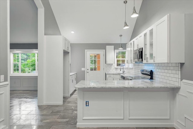 1572 Gardner Rd, Stroudsburg, PA 18360 - kitchen with appliances with stainless steel finishes, backsplash, light stone counters, vaulted ceiling, and glass insert cabinets