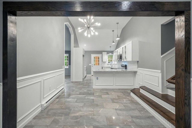 1572 Gardner Rd, Stroudsburg, PA 18360 - kitchen featuring a decorative wall, white cabinetry, light stone countertops, a peninsula, and a chandelier
