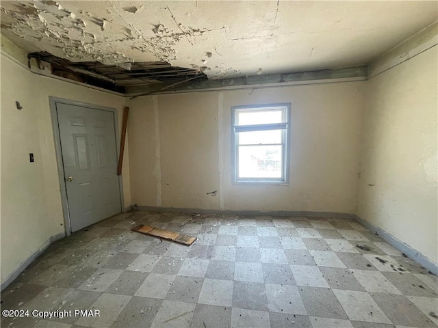 empty room featuring light floors and baseboards