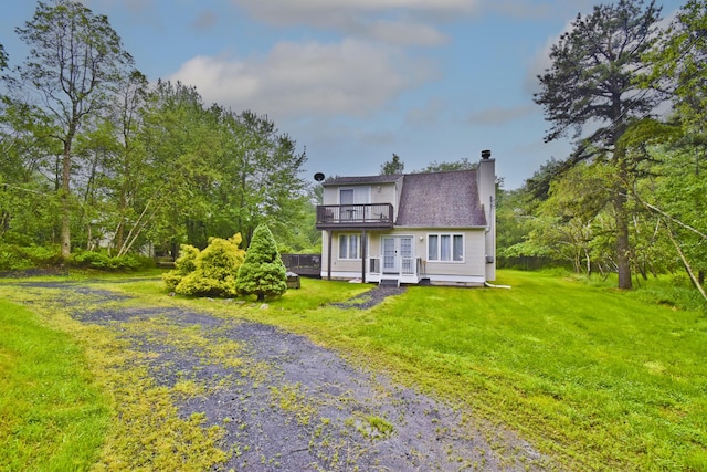594 Sullivan Trl, Long Pond, PA 18334 - rear view of house with a yard, a chimney, driveway, french doors, and a wooden deck