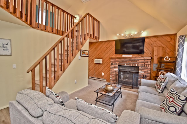 594 Sullivan Trl, Long Pond, PA 18334 - living area with a baseboard radiator, stairs, wooden walls, high vaulted ceiling, and a brick fireplace